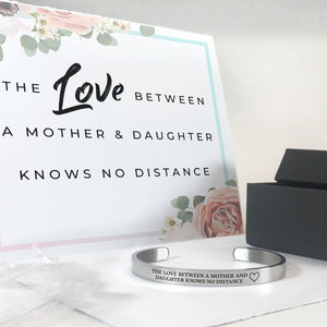 The love between a mother and daughter knows no distance bracelet in silver with a gift box, bag, and card in the background